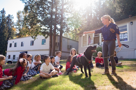 Field technician Julianne Ubigau teaches a classroom of second grade students about the work of Conservation Canines, a program with University of Washington’s Center for Conservation Biology.